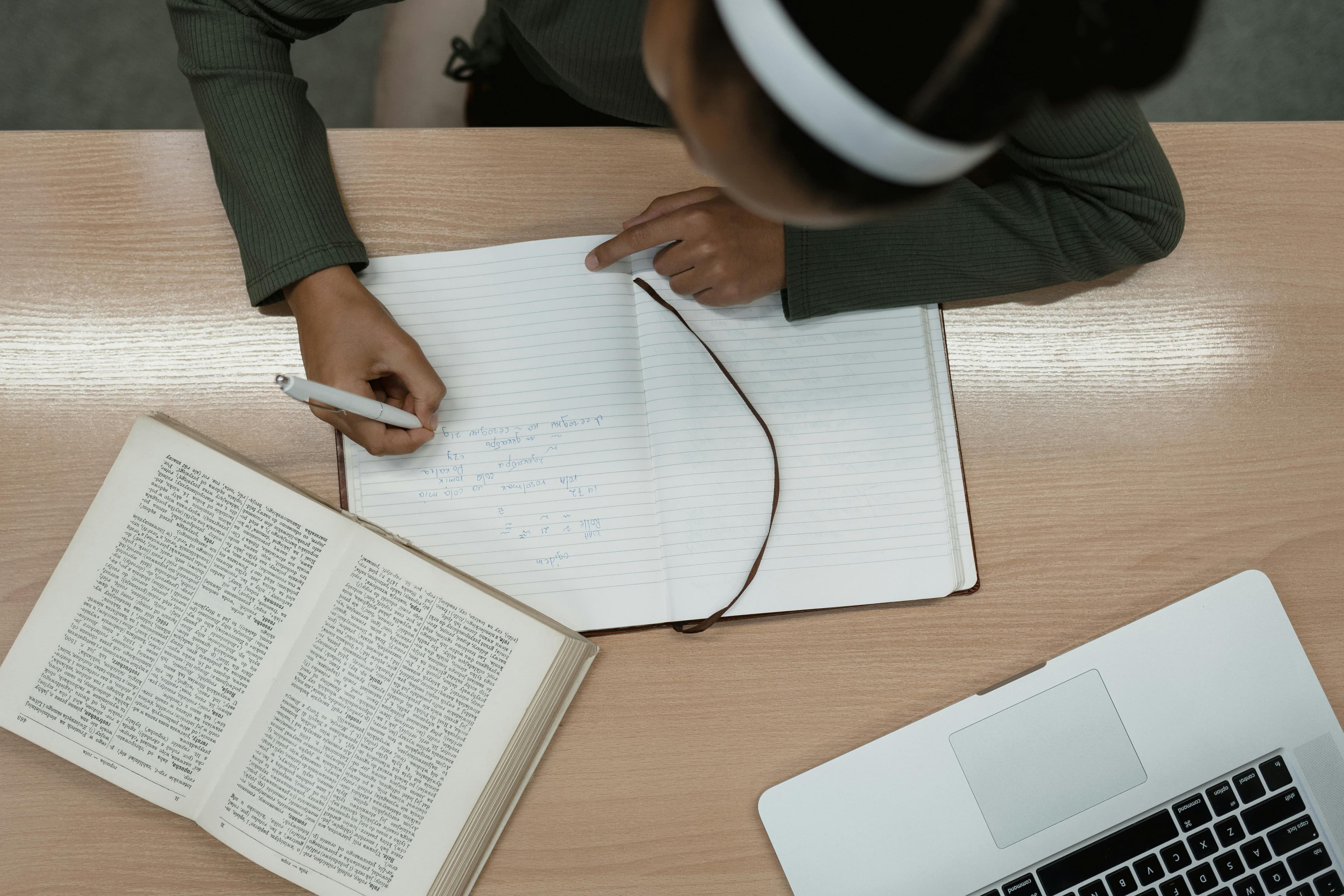Élève qui étudie avec un cahier et un ordinateur